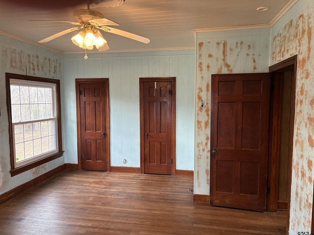 unfurnished bedroom featuring dark hardwood / wood-style flooring, crown molding, and ceiling fan