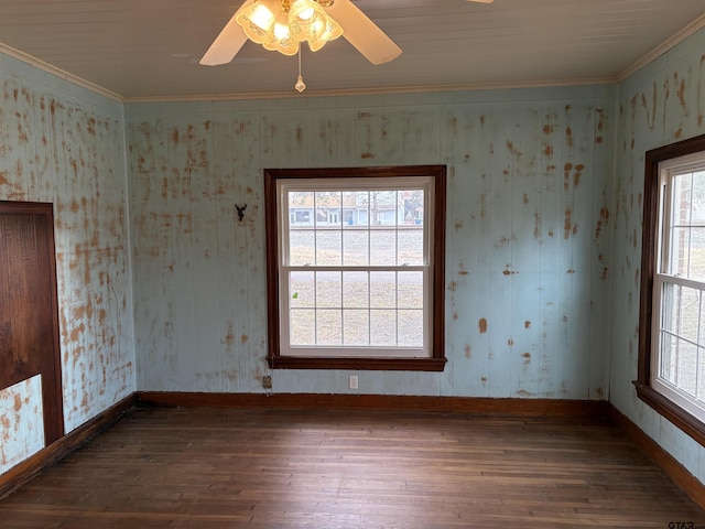 spare room featuring crown molding, ceiling fan, and dark hardwood / wood-style flooring