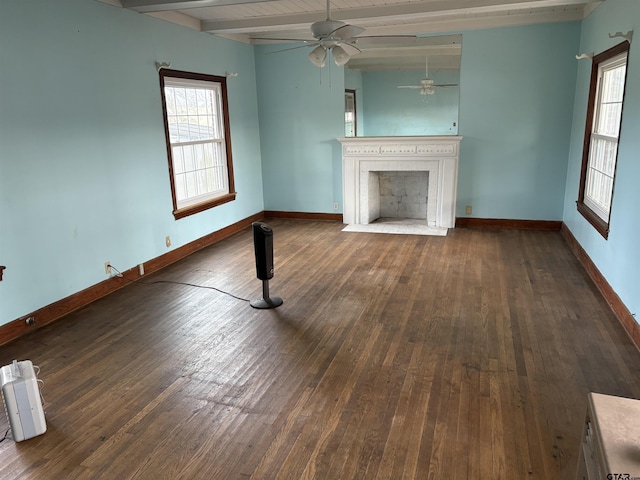 unfurnished living room featuring dark hardwood / wood-style floors, ceiling fan, and beam ceiling