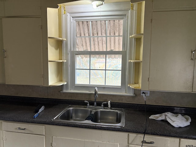 kitchen with white cabinetry and sink