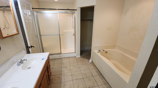 20501 Jak Ln, Chandler, TX 75758 - bathroom featuring a stall shower, double vanity, a bath, and tile patterned floors