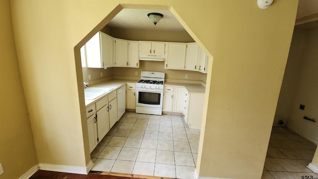 20501 Jak Ln, Chandler, TX 75758 - kitchen with white appliances, under cabinet range hood, a sink, light countertops, and light tile patterned flooring