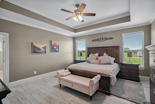 bedroom with crown molding, a raised ceiling, and wood finished floors
