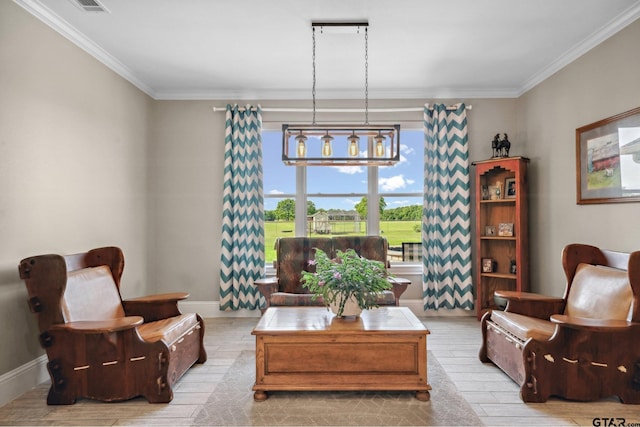 sitting room featuring baseboards, ornamental molding, and wood finished floors