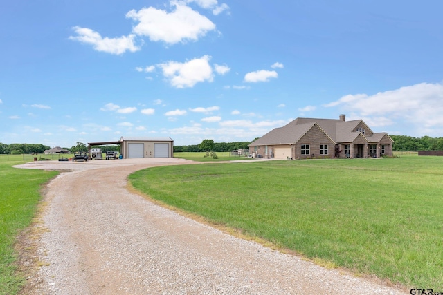 ranch-style home with an outdoor structure, stone siding, driveway, and a front yard