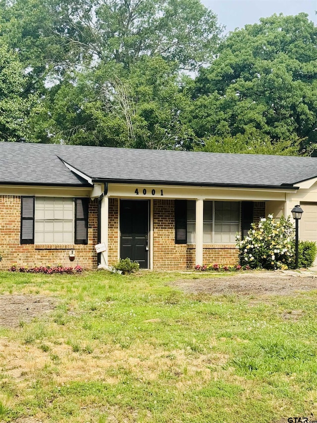 4001 Darrell Ln, Tyler, TX 75701 - single story home featuring brick siding, roof with shingles, and a front yard