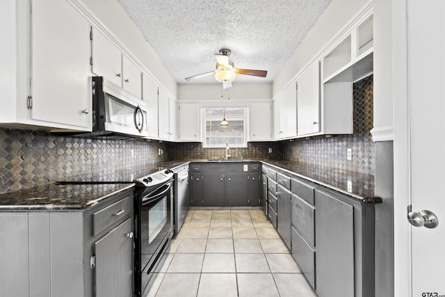 4001 Darrell Ln, Tyler, TX 75701 - kitchen with appliances with stainless steel finishes, a sink, a ceiling fan, white cabinetry, and a textured ceiling