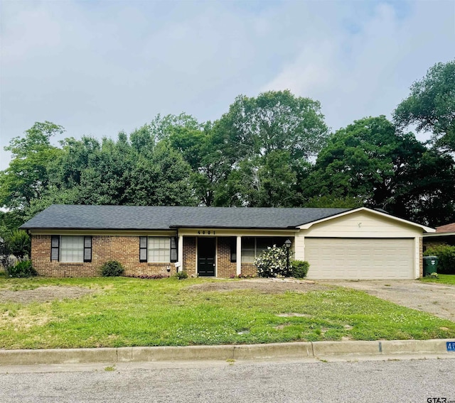 4001 Darrell Ln, Tyler, TX 75701 - ranch-style house featuring driveway, a garage, a front lawn, and brick siding