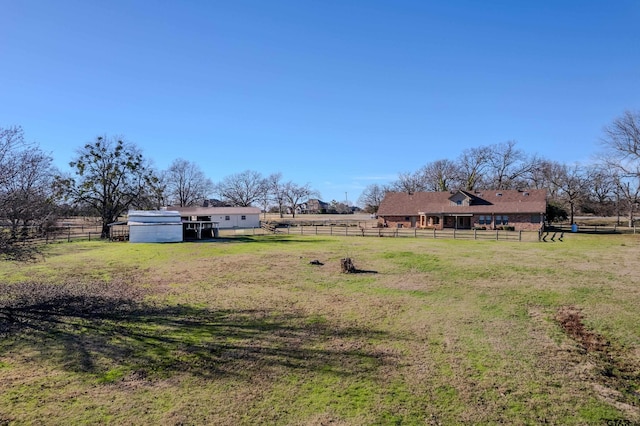 view of yard featuring an outbuilding and a rural view