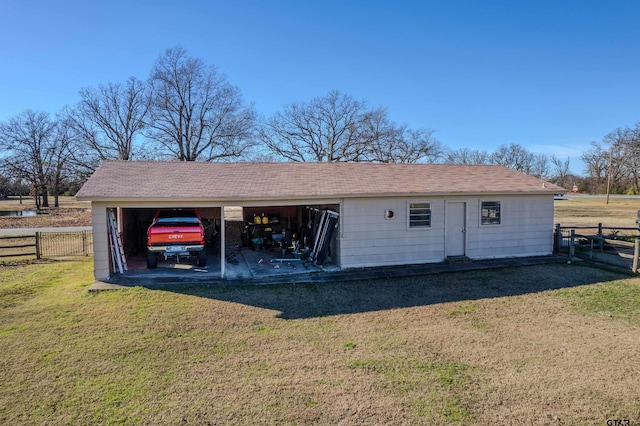 view of outdoor structure featuring a carport and a yard