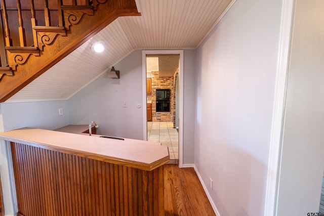 interior space featuring hardwood / wood-style floors, vaulted ceiling, and sink