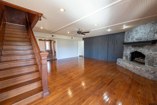 unfurnished living room featuring a fireplace, hardwood / wood-style flooring, and ceiling fan