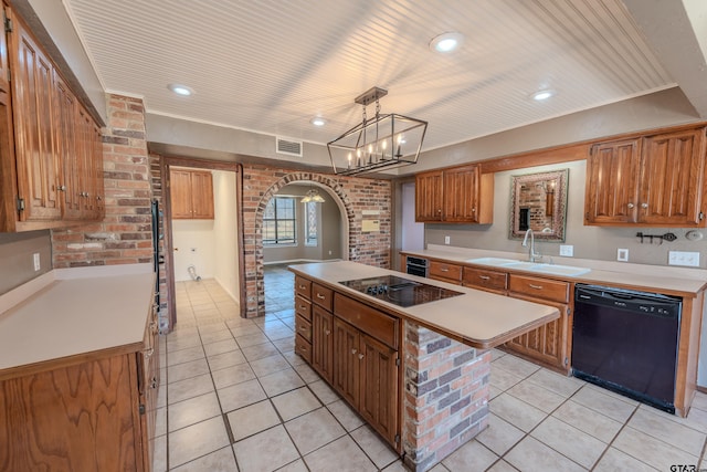 kitchen featuring visible vents, brick wall, arched walkways, a sink, and black appliances