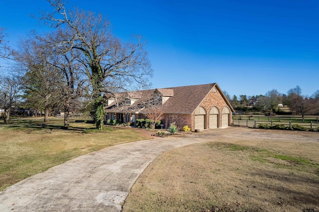 view of front facade with a garage and a front lawn