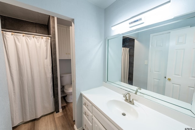 bathroom featuring vanity, curtained shower, toilet, and wood-type flooring