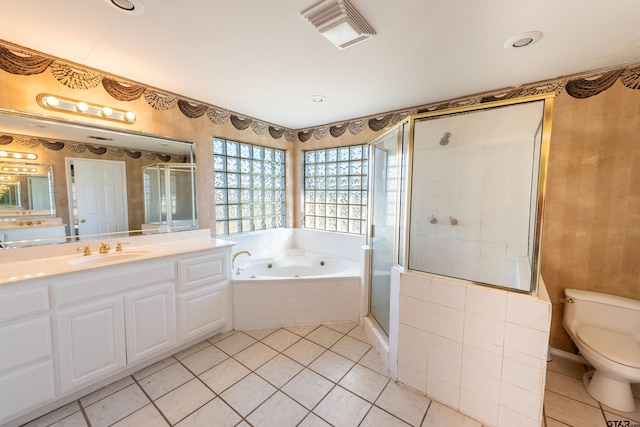 full bathroom featuring tile patterned floors, visible vents, toilet, a jetted tub, and a shower stall