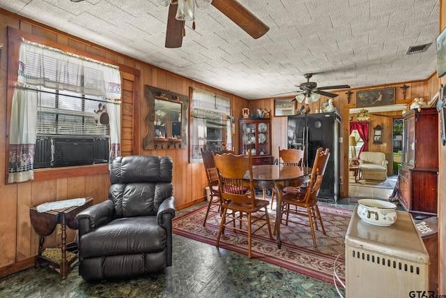 500 W Mclean St, Talco, TX 75487 - dining area with a ceiling fan, wooden walls, and cooling unit