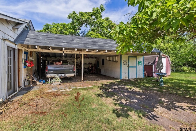 500 W Mclean St, Talco, TX 75487 - view of parking with a storage unit and a carport