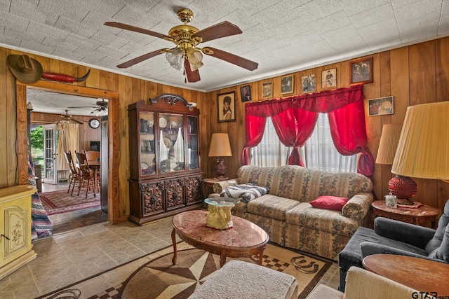 500 W Mclean St, Talco, TX 75487 - living room featuring ceiling fan and wood walls