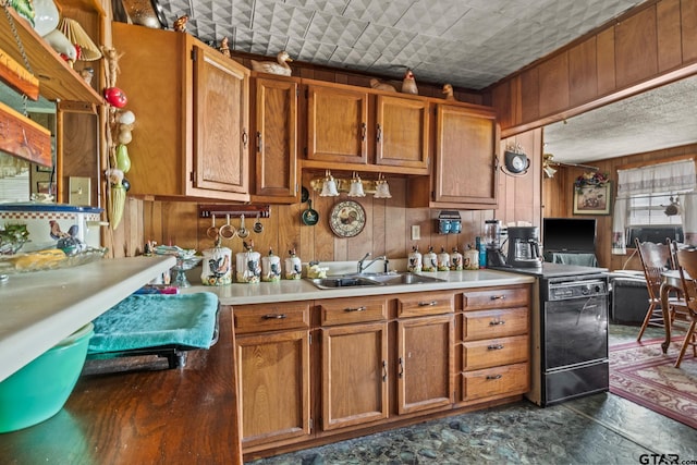 500 W Mclean St, Talco, TX 75487 - kitchen featuring a sink, wooden walls, light countertops, and brown cabinets