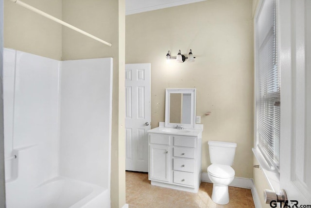 bathroom featuring baseboards, vanity, toilet, and tile patterned floors