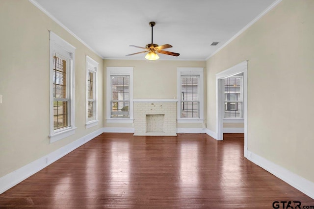 unfurnished living room featuring a brick fireplace, crown molding, and dark wood-style flooring