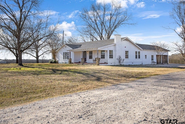 ranch-style home featuring a front yard