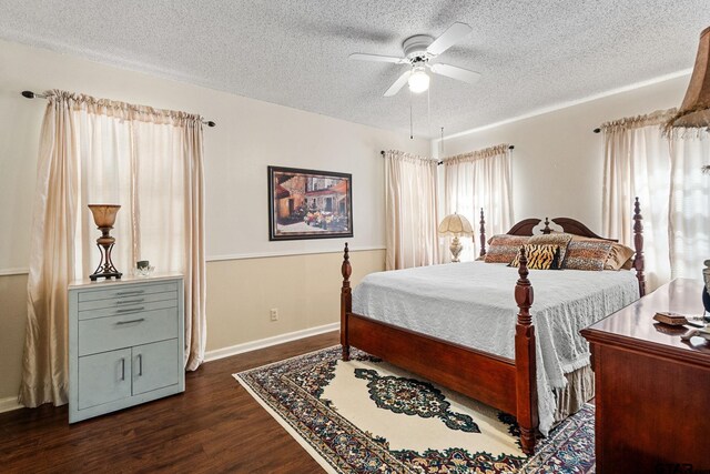 bedroom with ceiling fan, dark hardwood / wood-style floors, and a textured ceiling