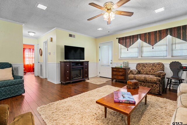 living room featuring a wealth of natural light, dark wood-type flooring, and a textured ceiling