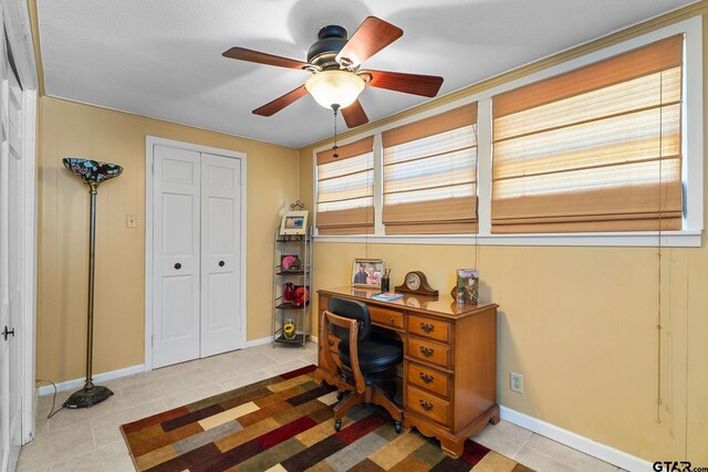 tiled home office featuring ceiling fan and a textured ceiling