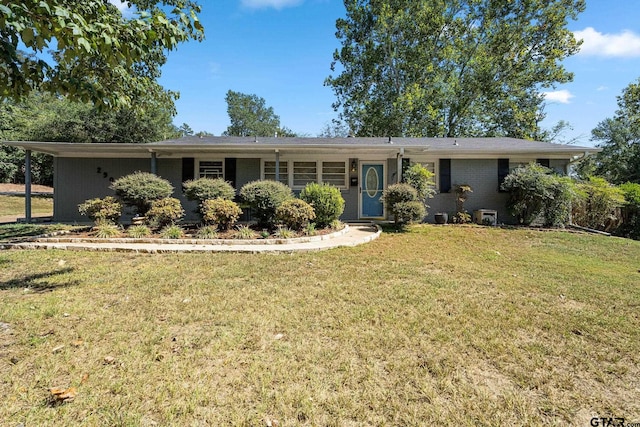 ranch-style house with a carport and a front lawn