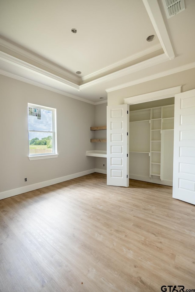529 Eland Way, Bullard, TX 75757 - unfurnished bedroom with a tray ceiling, crown molding, light wood-style floors, and a closet