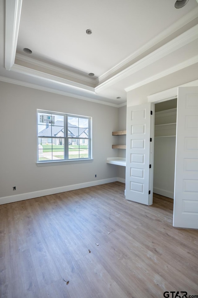 529 Eland Way, Bullard, TX 75757 - unfurnished bedroom featuring a raised ceiling, ornamental molding, and light wood finished floors