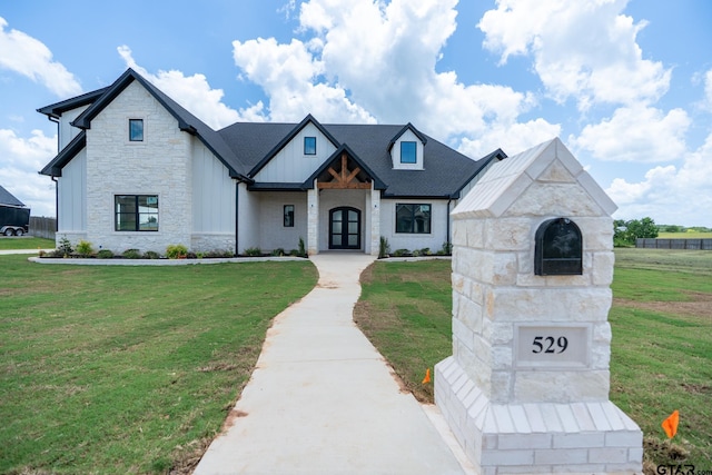 529 Eland Way, Bullard, TX 75757 - view of front of property featuring stone siding, a front yard, and board and batten siding
