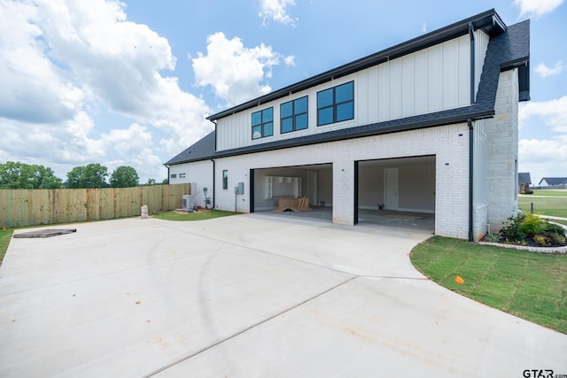 529 Eland Way, Bullard, TX 75757 - view of home's exterior with driveway, board and batten siding, brick siding, and an attached garage
