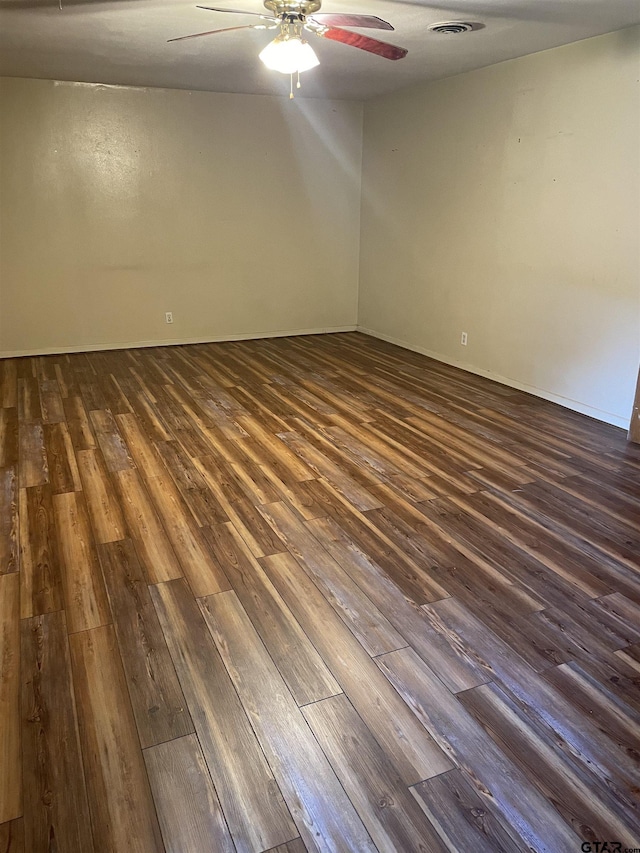 2800 Tanglewood, Tyler, TX 75703 - unfurnished room featuring dark wood-style floors, ceiling fan, and baseboards