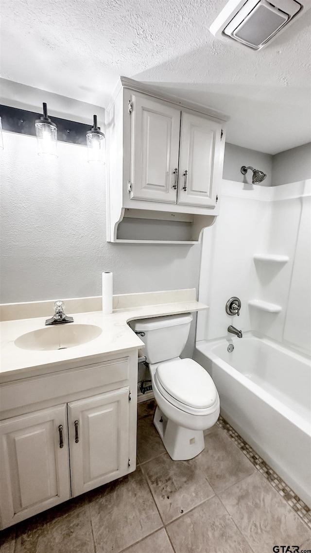 full bathroom with tile patterned floors, bathtub / shower combination, a textured ceiling, vanity, and toilet