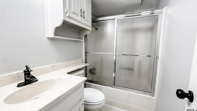 full bathroom featuring vanity, toilet, and shower / bath combination with glass door