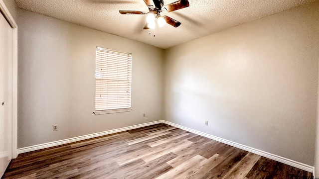 spare room featuring hardwood / wood-style floors, ceiling fan, and a textured ceiling