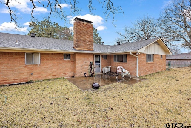 back of house featuring a yard and a patio area