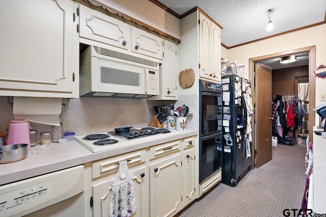 kitchen with ornamental molding, a textured ceiling, and black appliances