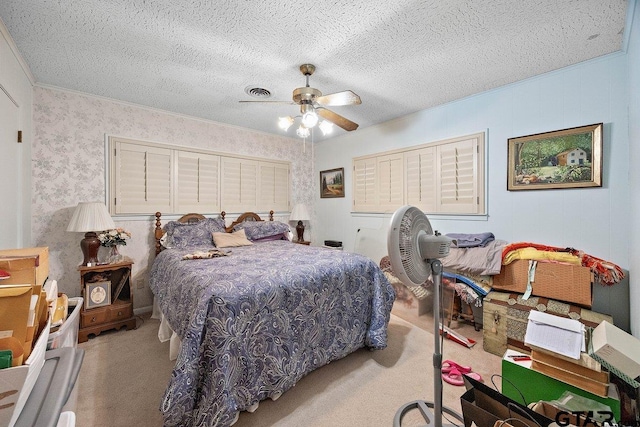 carpeted bedroom featuring ceiling fan and a textured ceiling