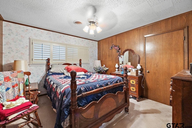 bedroom with crown molding, carpet flooring, and a textured ceiling