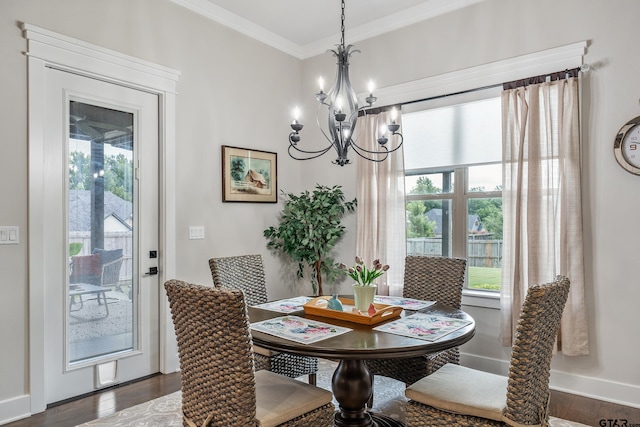 7306 Tule Creek Ln, Tyler, TX 75703 - dining area featuring a chandelier, dark wood-style floors, ornamental molding, and plenty of natural light