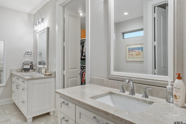 7306 Tule Creek Ln, Tyler, TX 75703 - bathroom featuring two vanities and baseboards