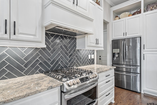 7306 Tule Creek Ln, Tyler, TX 75703 - kitchen featuring stainless steel appliances, custom range hood, decorative backsplash, and light stone countertops