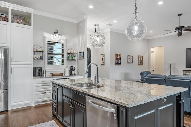 7306 Tule Creek Ln, Tyler, TX 75703 - kitchen featuring appliances with stainless steel finishes, crown molding, white cabinets, open floor plan, and dark wood finished floors