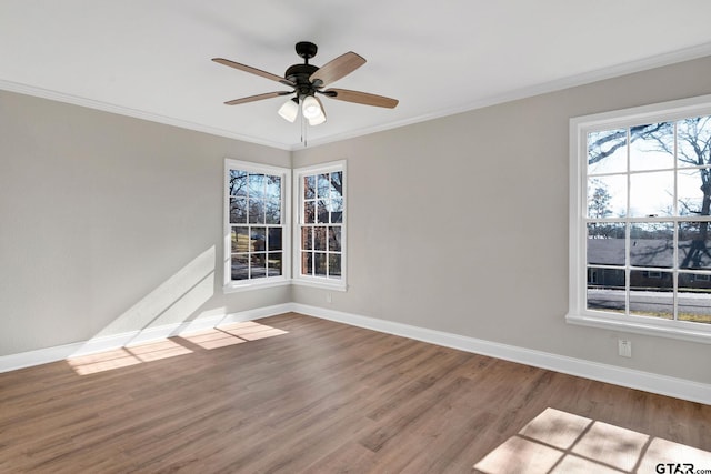 empty room featuring hardwood / wood-style flooring, crown molding, and ceiling fan