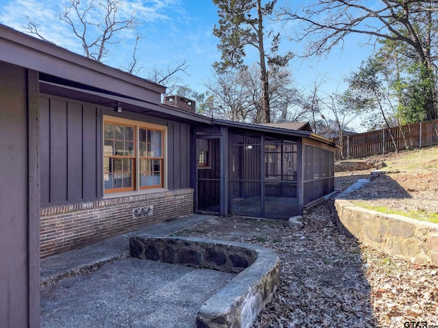 rear view of property with a sunroom