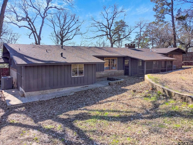 rear view of house featuring a sunroom and central AC unit